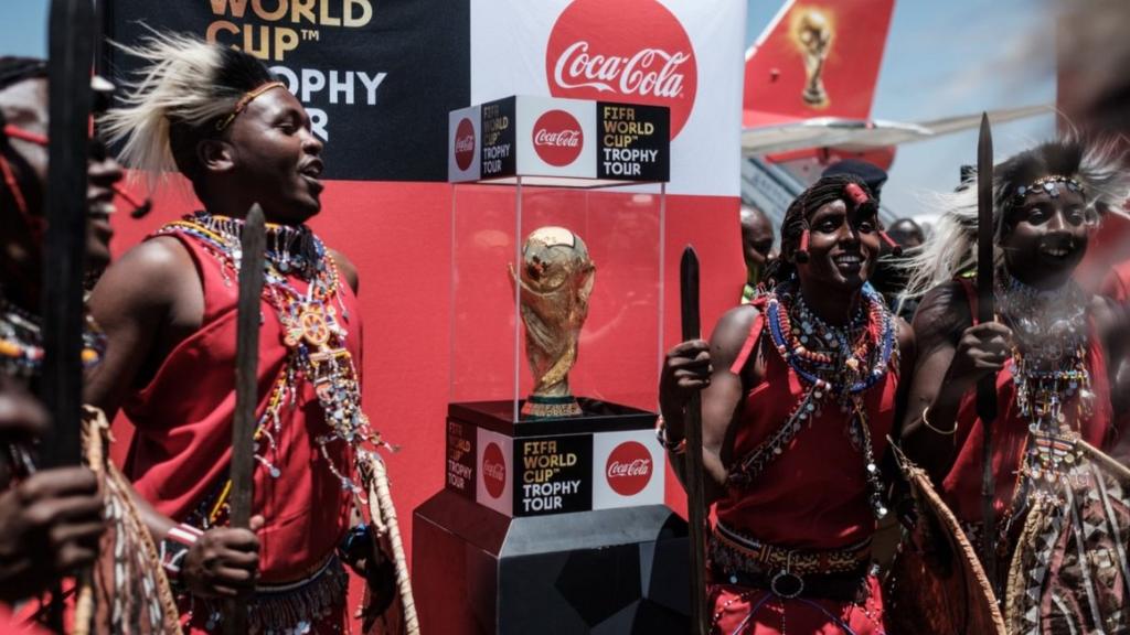 Kenya's Maasai tribe dancers perform upon the arrival of the special aircraft carrying the FIFA World Cup Trophy during its World Tour on February 26, 2018 at the Jomo Kenyatta International airport in Nairobi