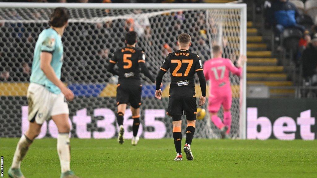 Wesley Hoedt watches on as his shot from the half-way line goes in to give Watford a 2-1 win at Hull