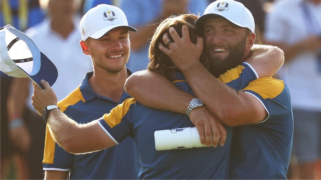 European players, including Tommy Fleetwood and Jon Rahm, embrace and celebrate after they win the Ryder Cup