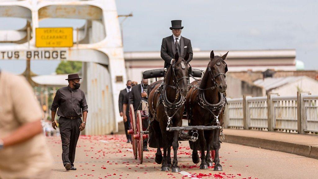 John Lewis' coffin is carried over bridge