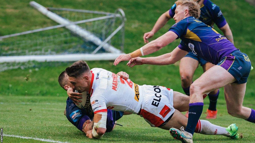 Tommy Makinson with his eyes on the tryline as he is tackled in the process of adding to St Helens' advantage against Halifax