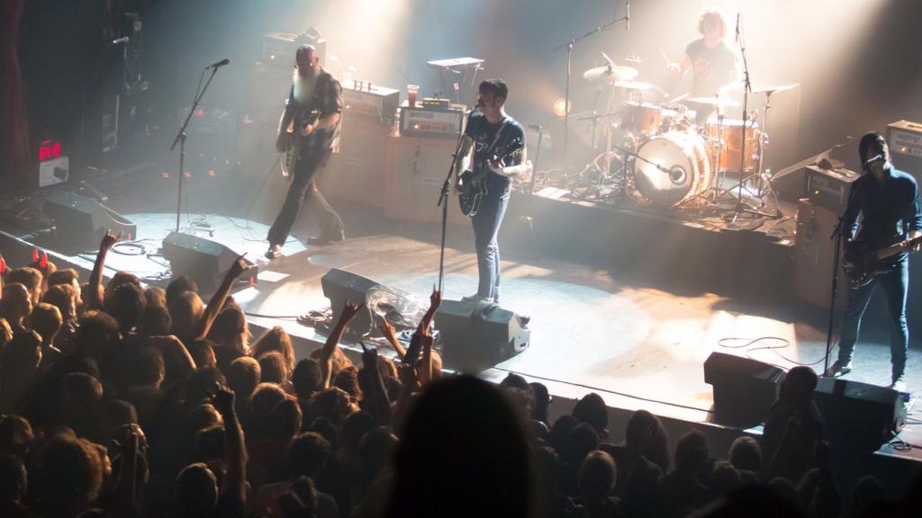 American rock group Eagles of Death Metal perform on stage on November 13, 2015 at the Bataclan concert hall in Paris, few moments before four men armed with assault rifles a stormed into the venue