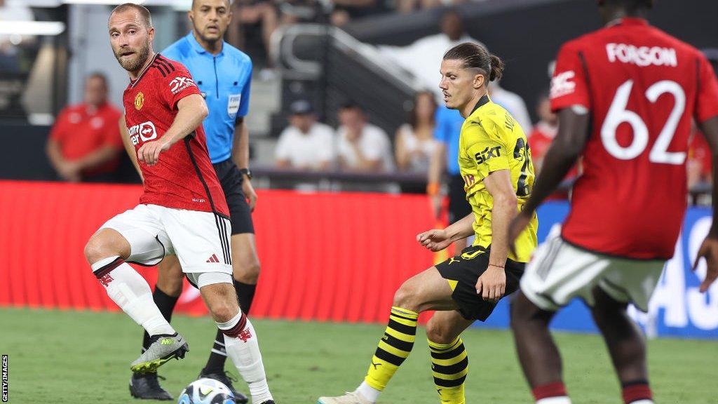 Christian Eriksen making a pass under pressure from Marcel Sabitzer