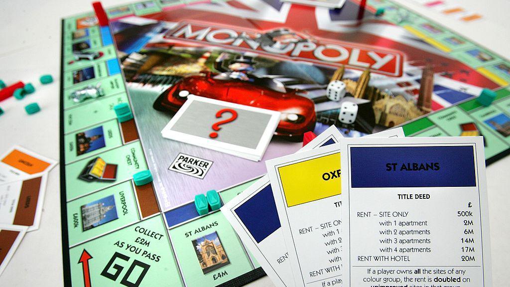 Monopoly board with player pieces and dice.