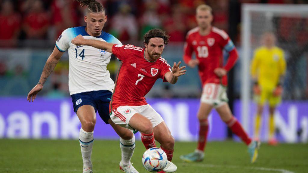 Joe Allen being pressured by England's Kalvin Phillips