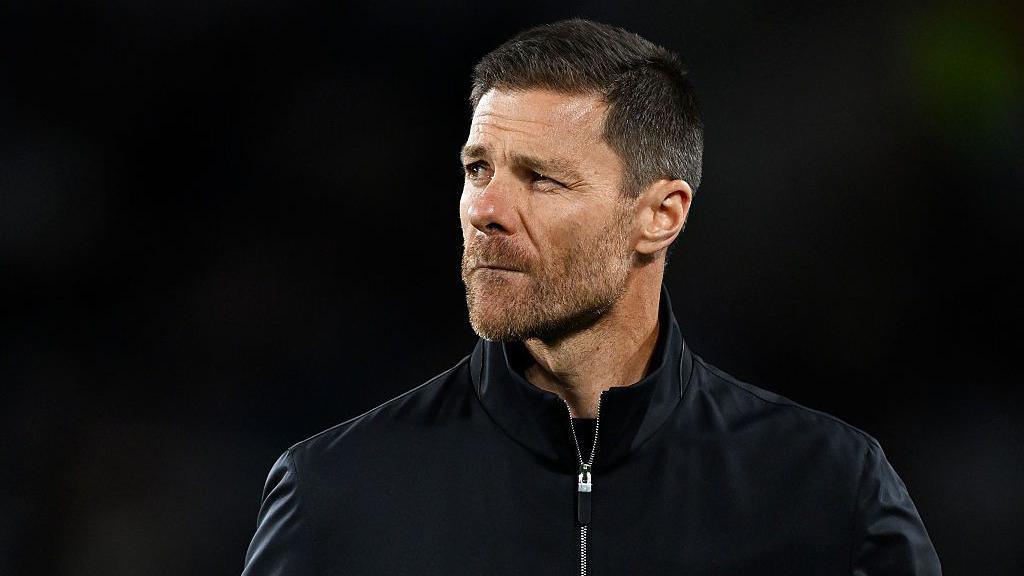 Xabi Alonso squinting while managing Chelsea on the touchline