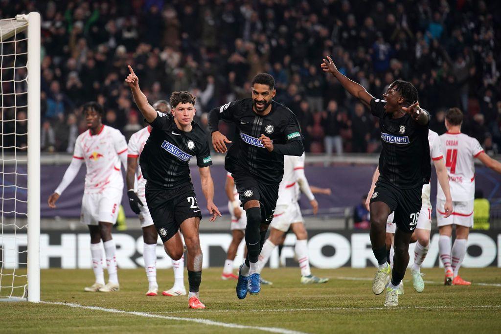 Arjan Malic of SK Sturm Graz celebrates scoring his team's first goal with team mates Seedy Jatta (R) and Gregory Wuethrich (C) during the UEFA Champions League 2024/25 League Phase MD8 match between SK Sturm Graz and RB Leipzig at Woerthersee Stadion