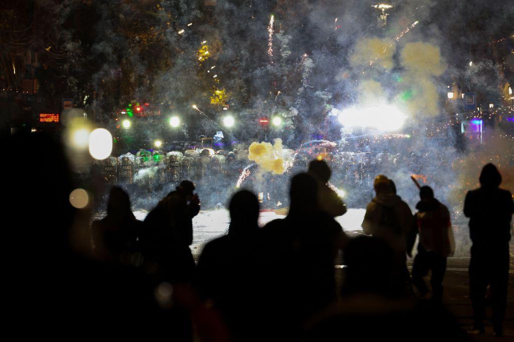 Anti-government protesters launch fireworks towards police during a sixth consecutive day of mass demonstrations 
