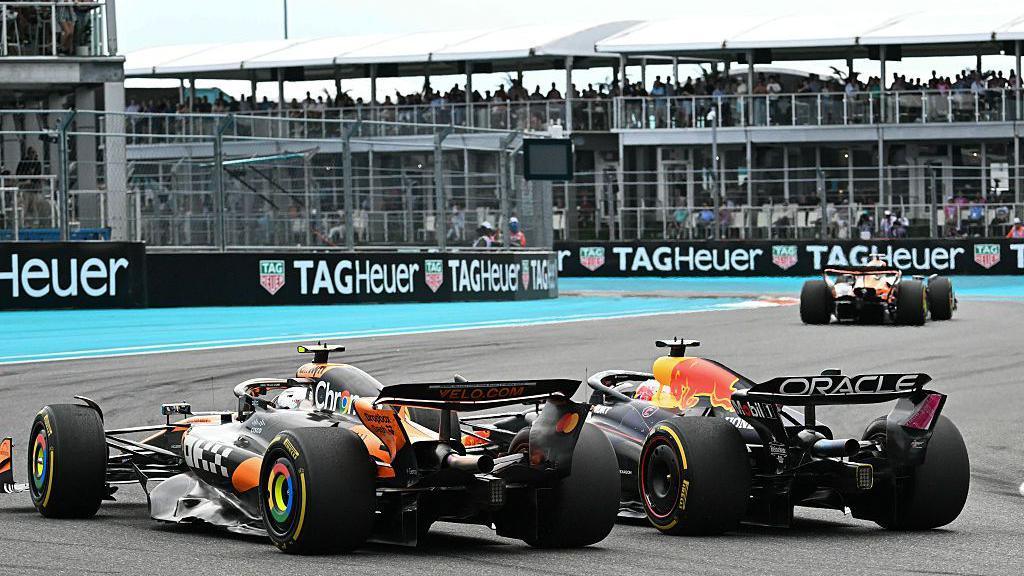 McLaren's Lando Norris, on the outside, is alongside Red Bull's Max Verstappen as they enter a right-hand corner during the 2025 Miami Grand Prix