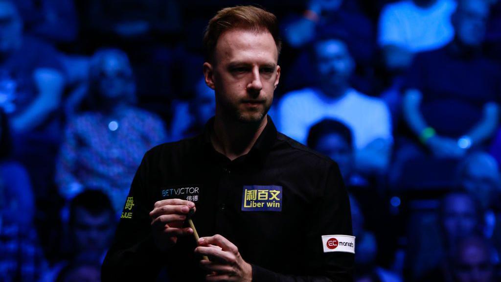 Judd Trump chalks his cue at the English Open