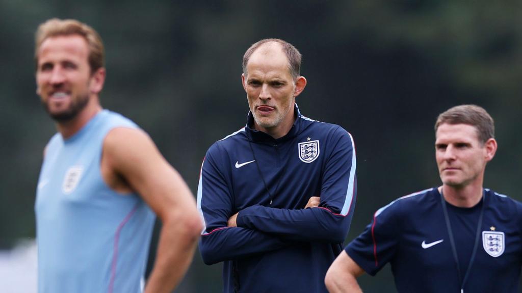 England manager Thomas Tuchel stands behind captain Harry Kane (left of centre) and assistant manager Antony Barry (right)