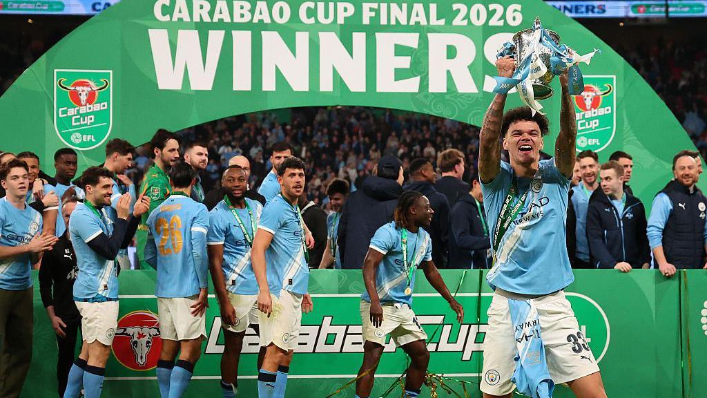 Nico O'Reilly of Manchester City celebrates with the trophy
