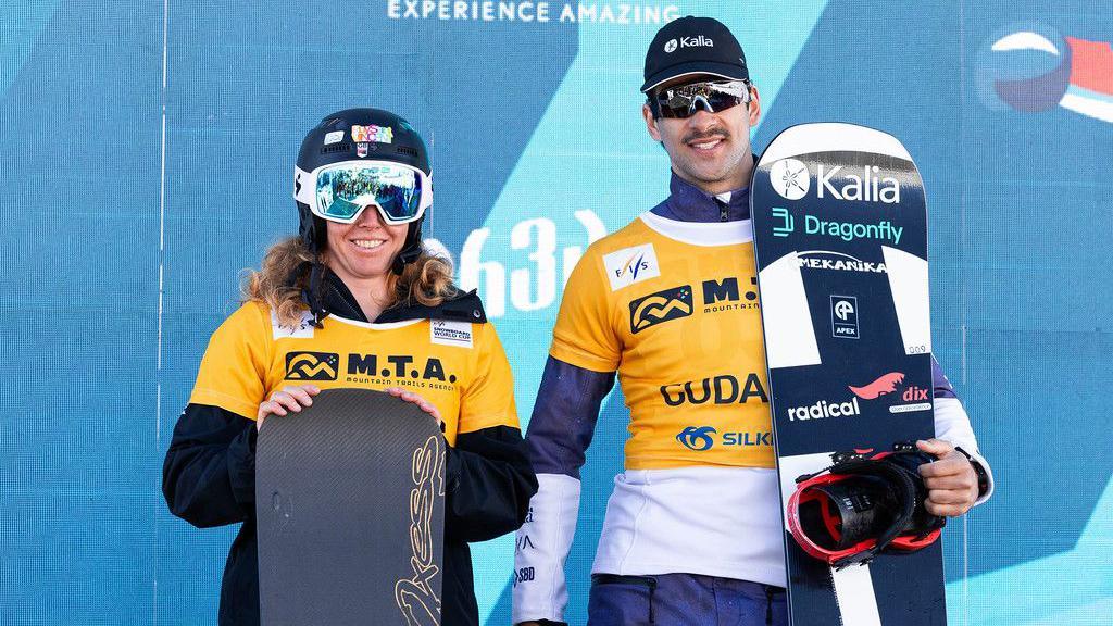 Charlotte Bankes of Great Britain and Canada's Eliot Grondin pose with their snowboards at the Gudauri ski resort in Georgia