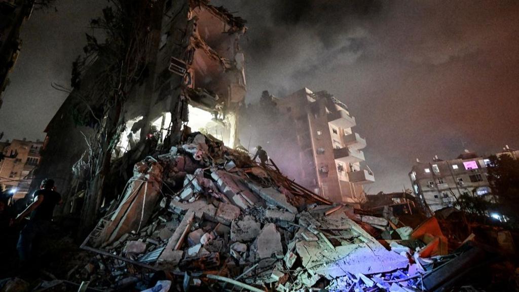 Rescue personel work at a residential building following missile attack from Iran on Israel