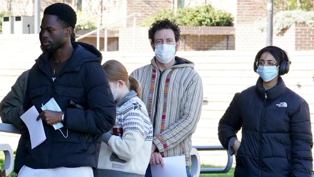 People queue for antibiotics at the University of Kent