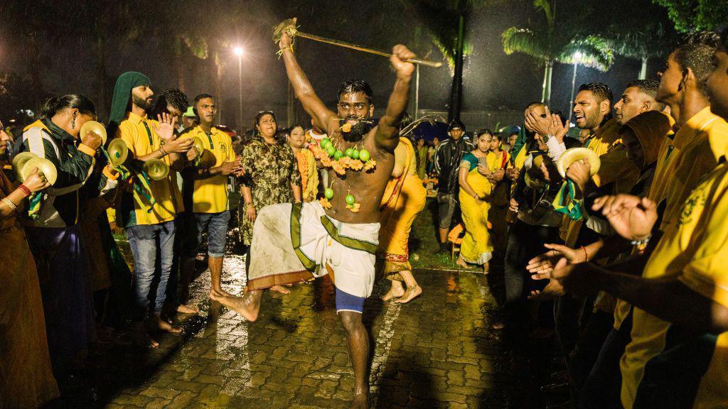 A man with objects pierced on his chest dances in a trance during the Thaipoosam Kavady festival in Durban , South Africa - Monday 10 February 2025