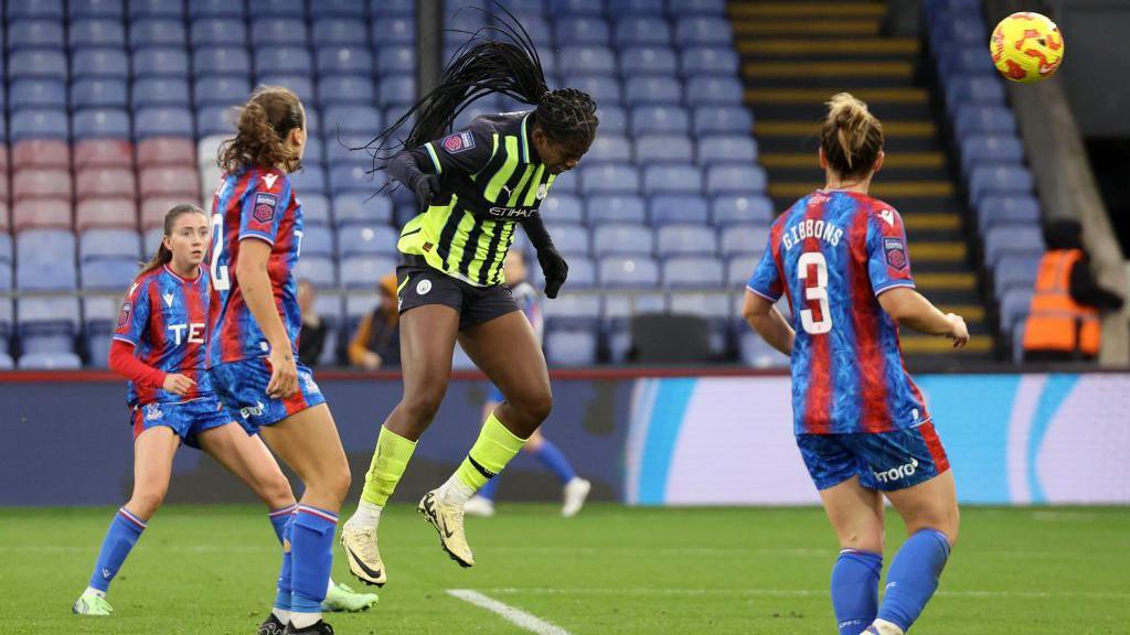 Khadija Shaw heads the ball towards goal