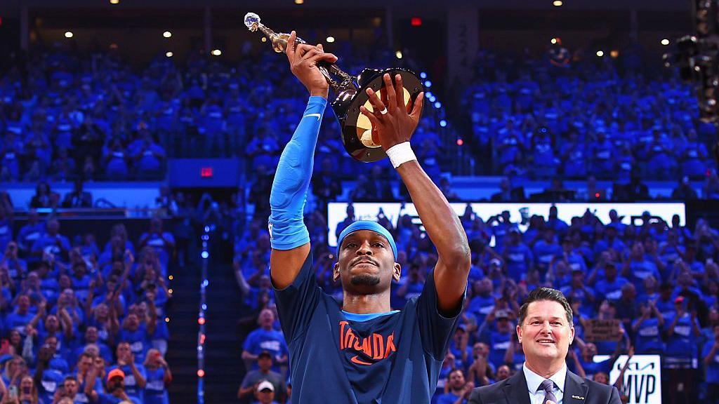 Shai Gilgeous-Alexander lifting the Most Valuable Player trophy