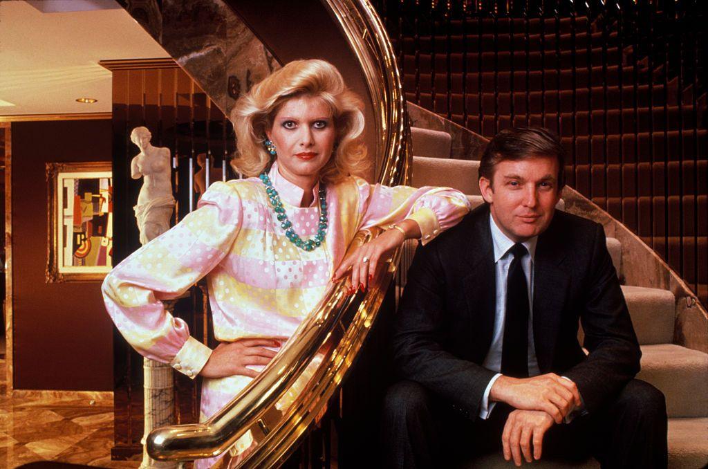 Donald and Ivana Trump pose beside the golden banister of their staircase.