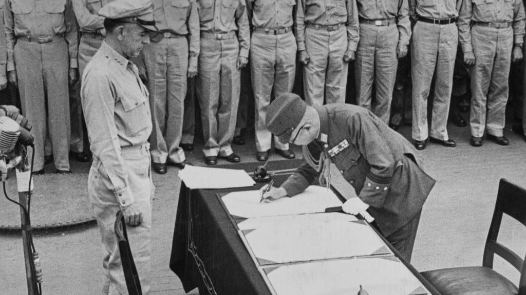 American military officer Richard K Sutherland watches as General Yoshijiro Umezu  signing the Japanese Instrument of Surrender on behalf of the Japanese Government, on board USS Missouri (BB-63) in Tokyo Bay, Japan, 2nd September 1945
