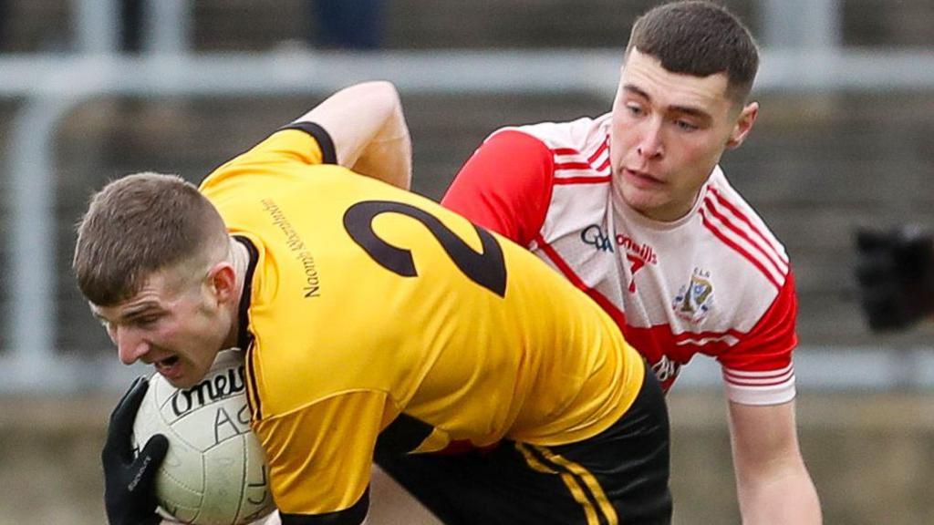 St Eunan's player Aaron Deeney attempts to get past Dungloe's Karl Magee in the Donegal Football Final