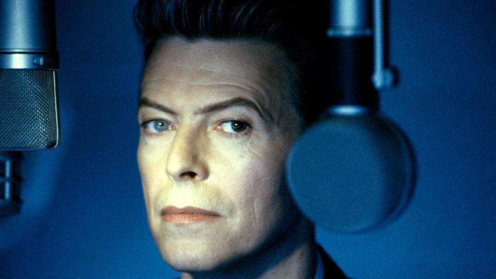 David Bowie next to a microphone, photographed later in his career