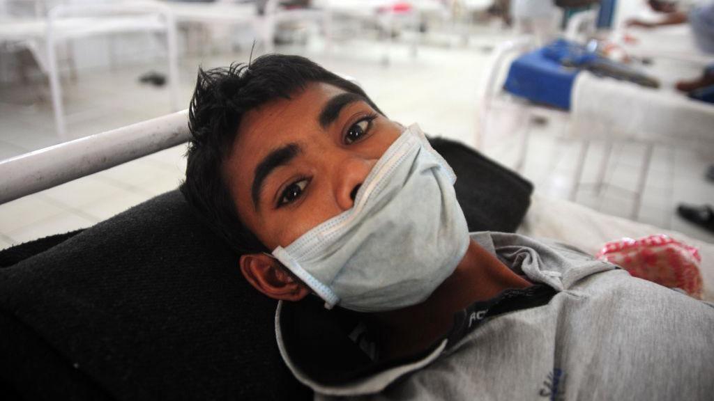 A young male tuberculosis patient covers his mouth with a mask during treatment in a government TB hospital on "World Tuberculosis Day" in Allahabad.