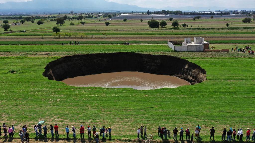 Aerial view of a sinkhole that was found by farmers in a field of crops in  Mexico in 2021