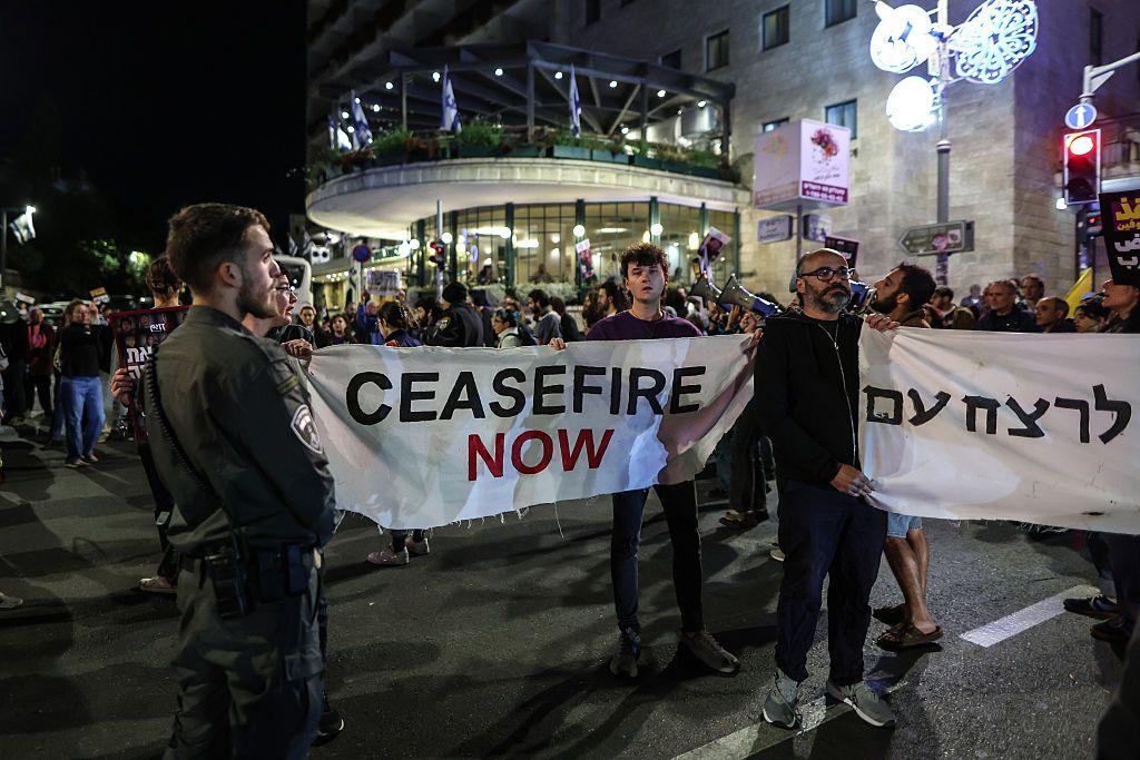 Protesters in Tel Aviv hold a sign calling for a ceasefire