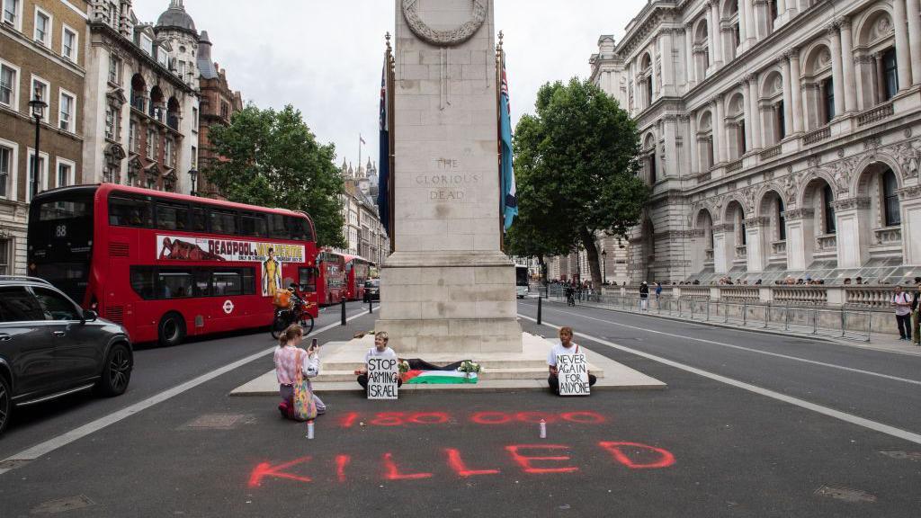 Two were videoed spray painting the tarmac in front of the Cenotaph