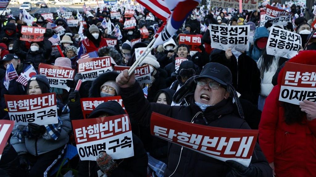 Supporters of South Korean President Yoon Suk Yeol gather as members of the Corruption Investigation Office for High-ranking Officials and police officials wait to enter the presidential residence in Seoul, South Korea, 03 January 2025.