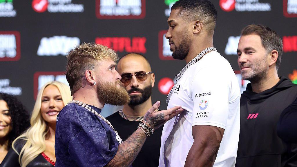 Jake Paul touches Anthony Joshua's chest