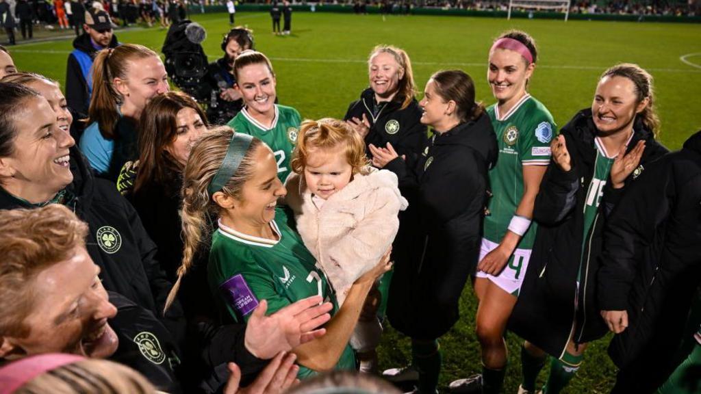 Julie-Ann Russell with baby Rosie and her team-mates