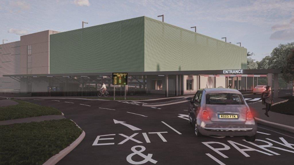 An artist's impression of what the new multi-storey car park will look like. It shows a light green coloured enclosed car park with an entrance on the right and a car driving into it