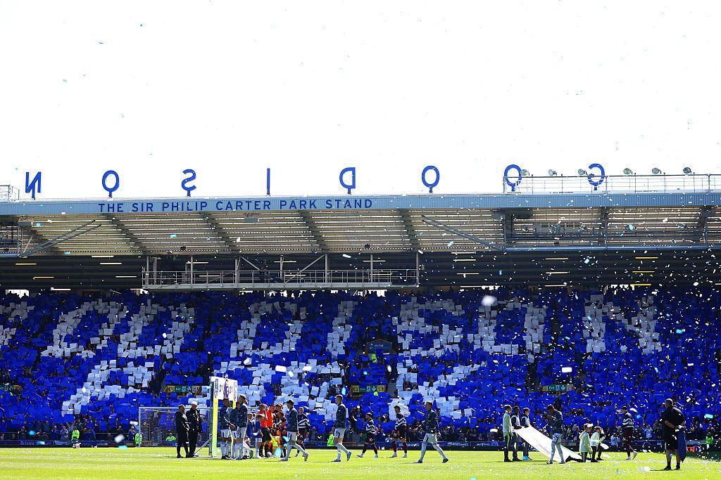 Everton fans hold up cards spelling out Goodison Park at Goodison Park