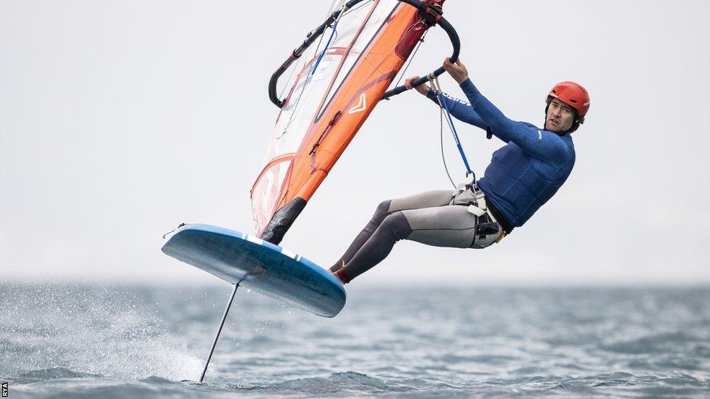 Sam Sills floats above the water on his iQFOiL