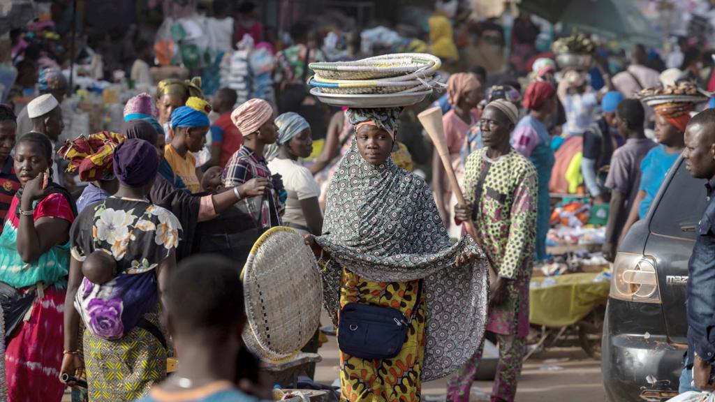 A woman walks in the market of Korhogo, Ivory Coast - January 2024