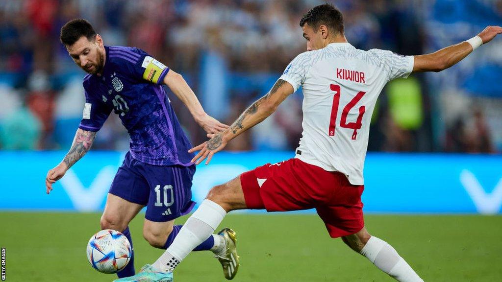 Poland's Jakub Kiwior and Argentina's Lionel Messi