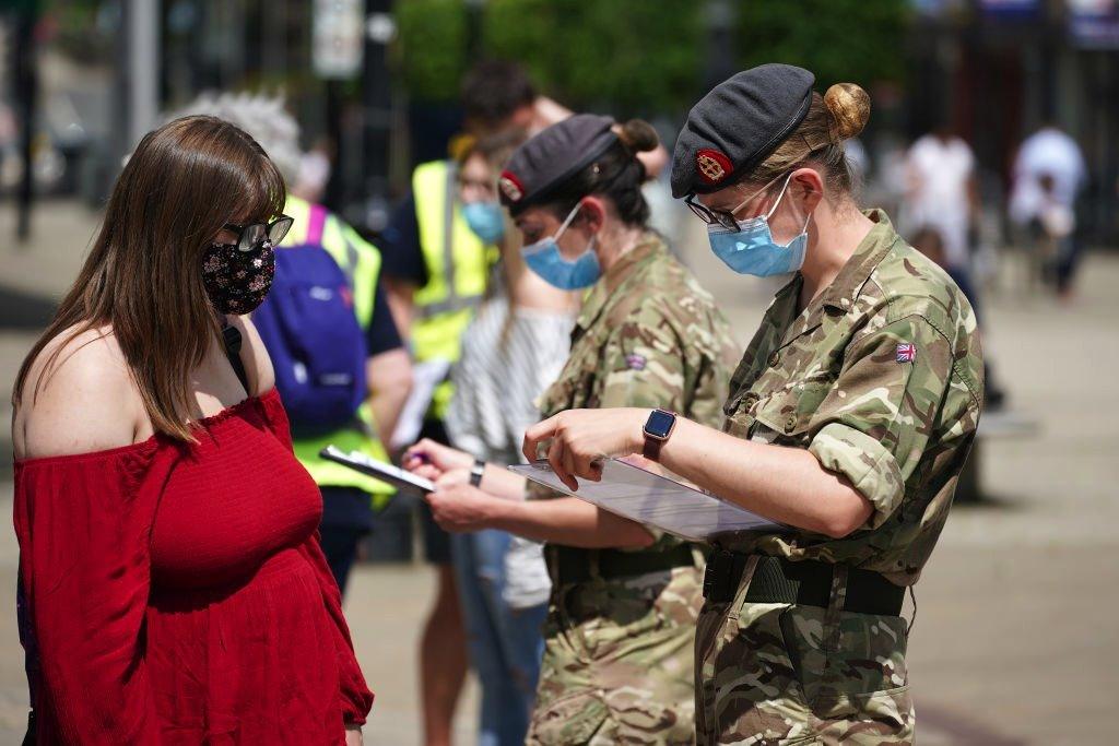 Combat medics from Queen Alexandra's Royal Army Nursing Corps vaccinate members of the public at a rapid vaccination centre