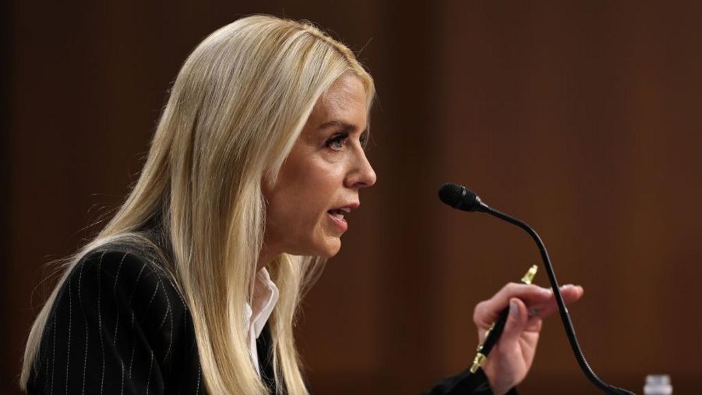 Pam Bondi speaking into a microphone