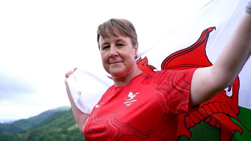 Anwen Butten flies the Wales flag before the 2022 Commonwealth Games