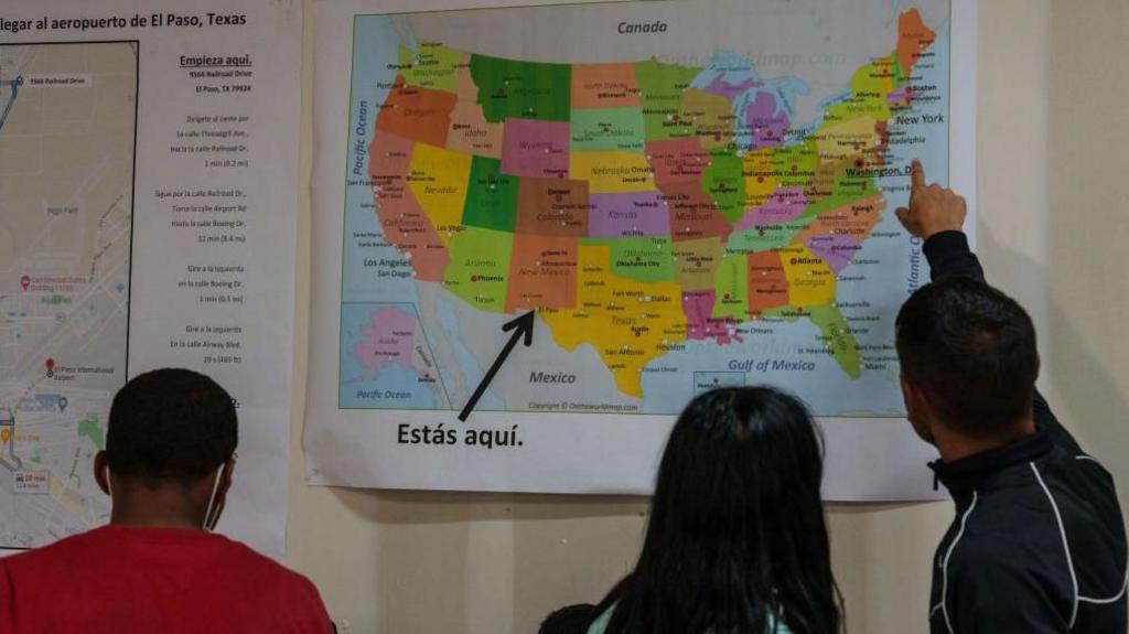 Migrants from Venezuela view a map of the US at a Welcome Center in El Paso, Texas, US, on Thursday, Sept. 22, 2022