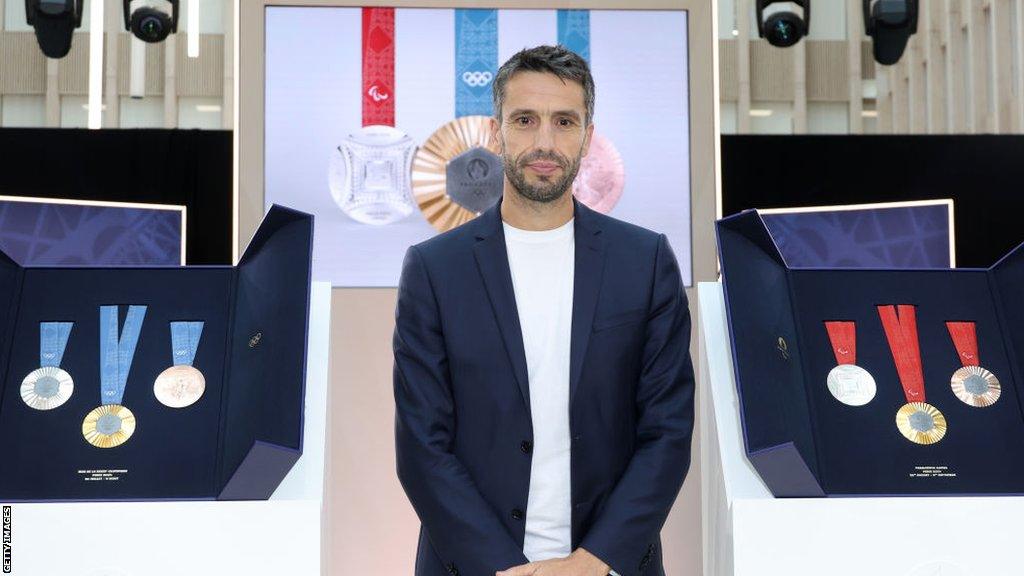 Tony Estanguet, president of the Paris 2024 Olympic and Paralympic Games, poses with the medals