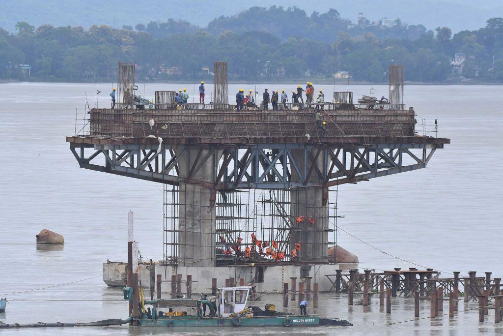 Workers are working on the construction of a bridge over the Brahmaputra River in Guwahati, India, on July 23, 2024.