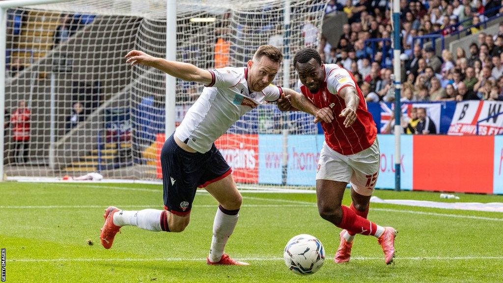 Tolaji Bola battles for the ball against Bolton Wanderers