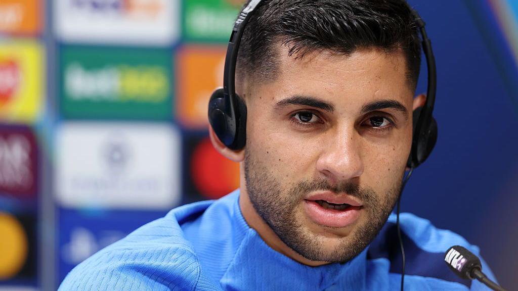 Cristian Romero of Tottenham Hotspur speaks to the media