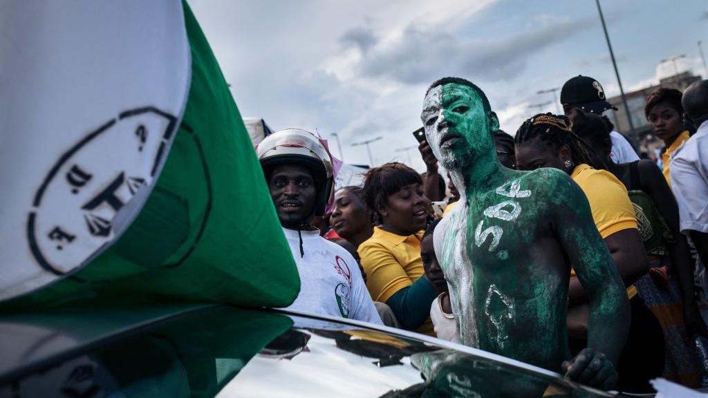 A man painted in green and white colours 