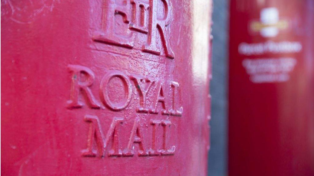 A red royal mail post box