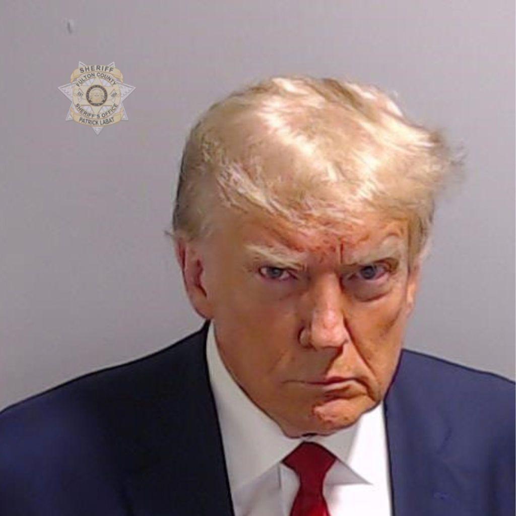 Donald Trump, in navy blazer and red tie, poses for his booking photo at the Fulton County Jail on 24 August, 2023, in Atlanta, Georgia. 