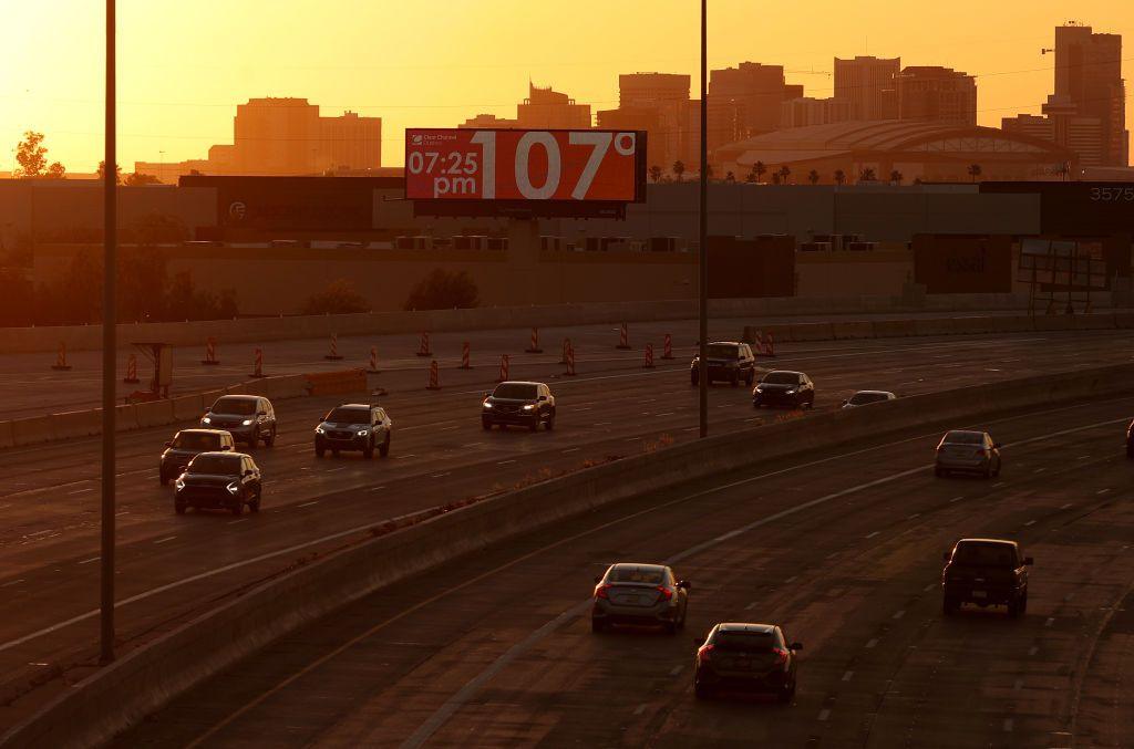 US motorway at dusk with temperature sign showing 107F